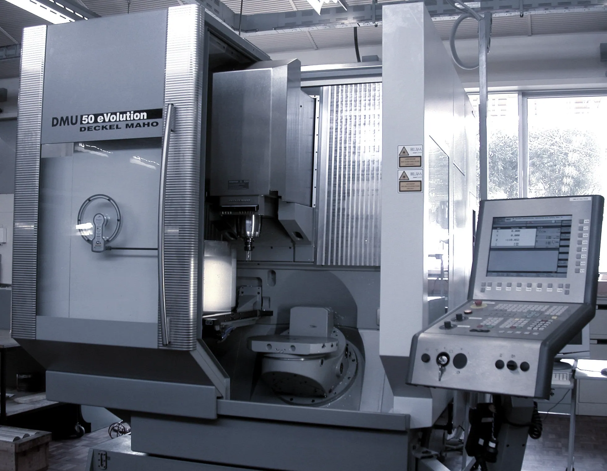 A CNC machining centre with its operator control panel and tool spindle visible